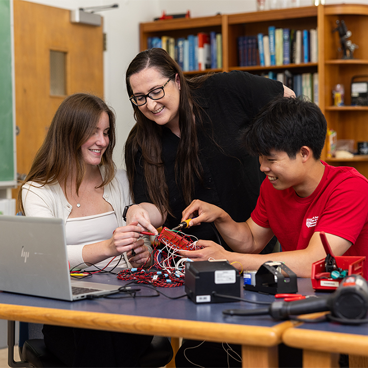 Emily Hawkins teaching physics at LMU to two students
